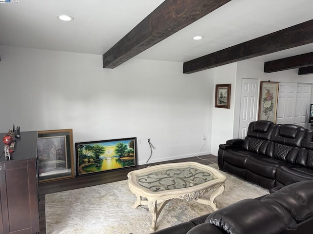 living room with beam ceiling and hardwood / wood-style floors