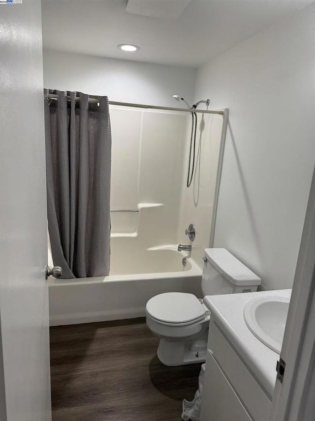 full bathroom featuring toilet, shower / tub combo, hardwood / wood-style flooring, and vanity