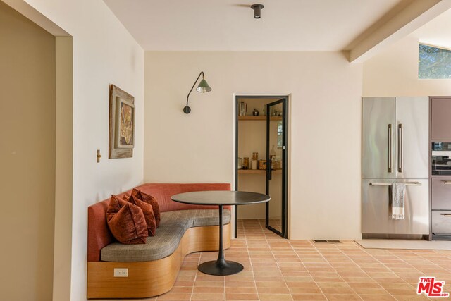 hall featuring light tile patterned floors