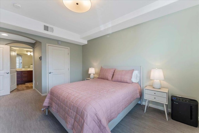 carpeted bedroom with ensuite bathroom