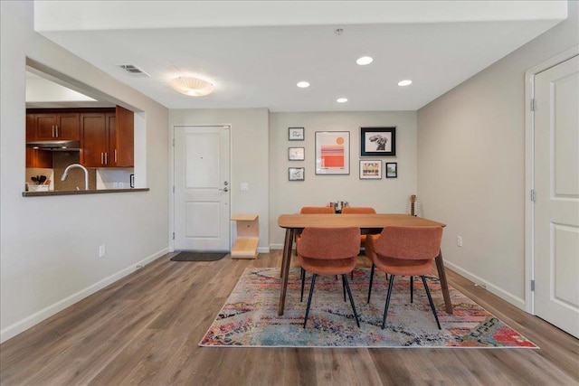 dining space with hardwood / wood-style flooring