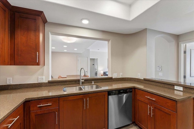 kitchen featuring dark stone countertops, sink, and stainless steel dishwasher