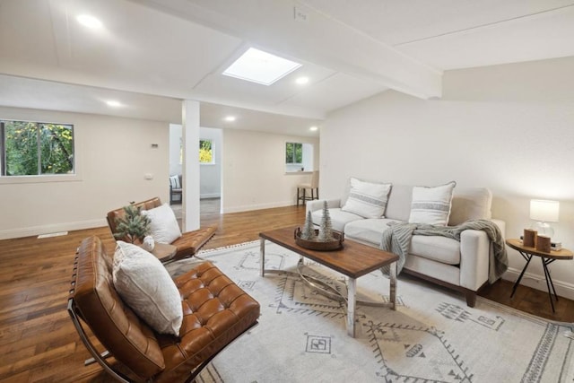 living room featuring hardwood / wood-style floors and vaulted ceiling with beams