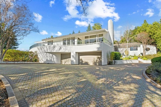 view of front of property with a balcony and a garage