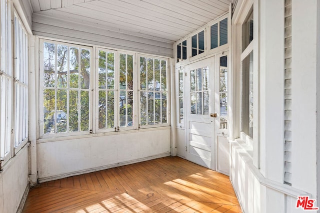 unfurnished sunroom with vaulted ceiling