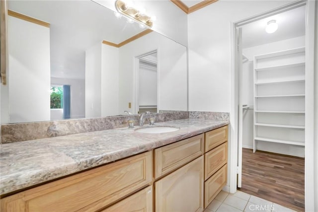 bathroom featuring tile patterned floors, vanity, and ornamental molding