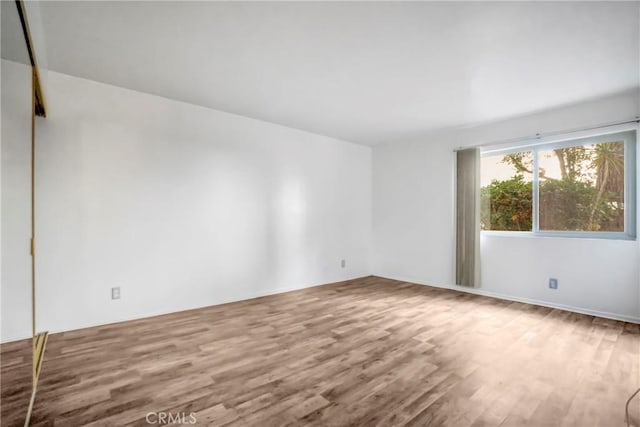 unfurnished room featuring wood-type flooring