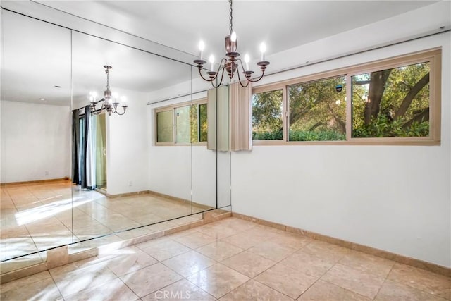 tiled empty room featuring a wealth of natural light and an inviting chandelier