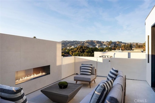 view of patio with an outdoor living space with a fireplace