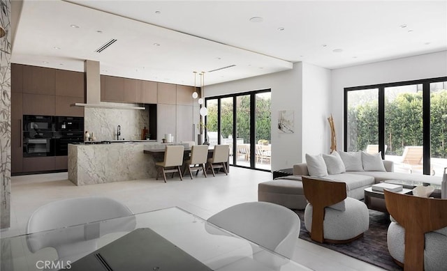 living room featuring a wealth of natural light and french doors