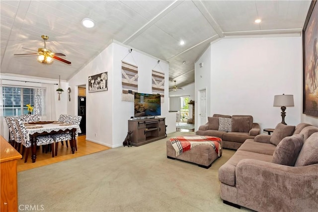 carpeted living room featuring ceiling fan and vaulted ceiling