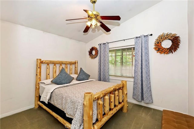 bedroom with ceiling fan, dark carpet, and lofted ceiling