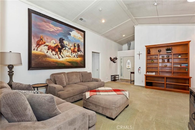 carpeted cinema room with vaulted ceiling