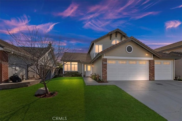 front facade featuring a garage and a lawn