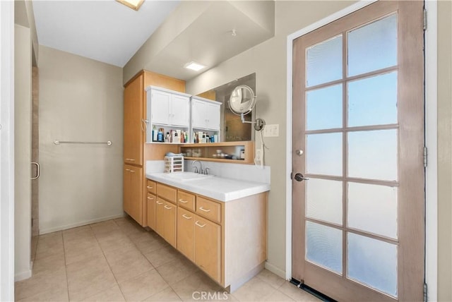 bathroom featuring tile patterned flooring and vanity