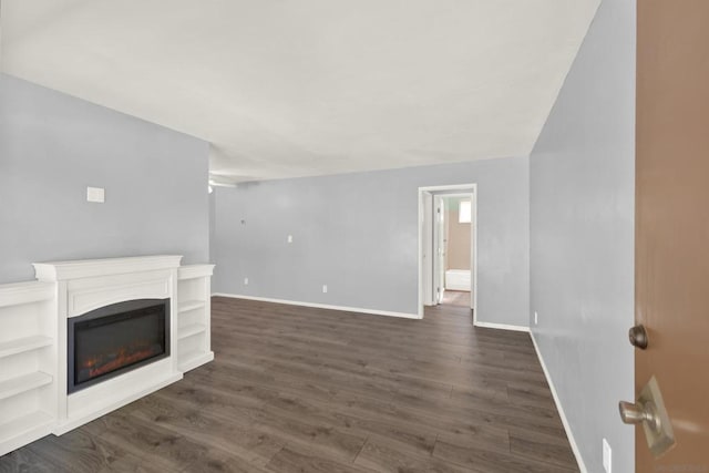 unfurnished living room with dark hardwood / wood-style flooring