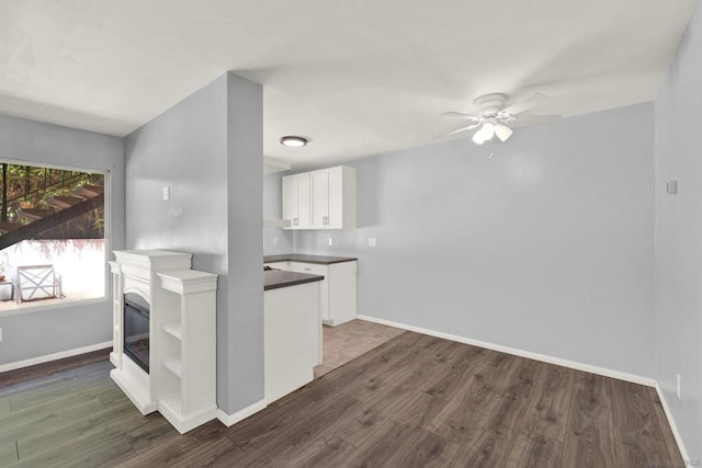 kitchen featuring dark hardwood / wood-style floors, white cabinets, and ceiling fan