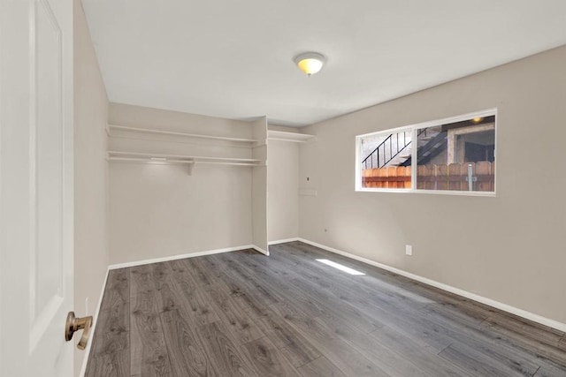 unfurnished bedroom with dark wood-type flooring and a closet