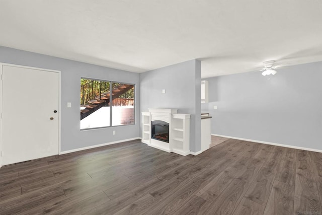 unfurnished living room with ceiling fan and dark hardwood / wood-style flooring