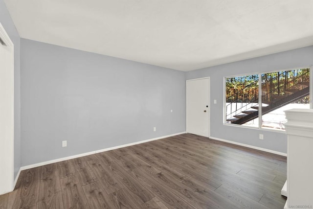 spare room featuring dark hardwood / wood-style flooring