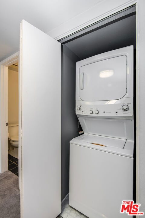 laundry area with stacked washer / dryer