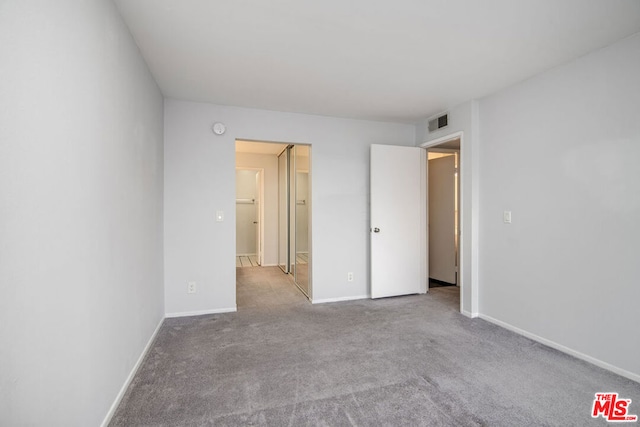 unfurnished bedroom with light carpet