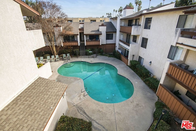 view of swimming pool featuring a patio area