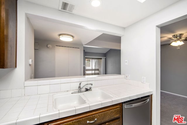 kitchen featuring tile counters, ceiling fan, sink, and stainless steel dishwasher