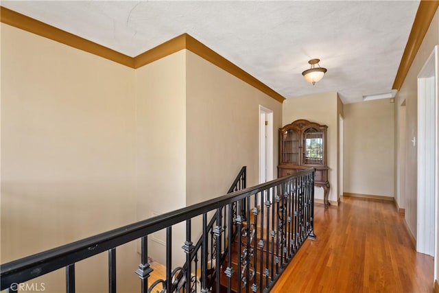 4485 Myrtle Ave, Long Beach, CA 90807 - hallway featuring baseboards, wood finished floors, and an upstairs landing