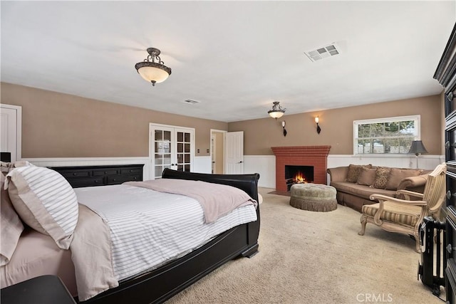 4485 Myrtle Ave, Long Beach, CA 90807 - bedroom with visible vents, a wainscoted wall, carpet flooring, french doors, and a brick fireplace