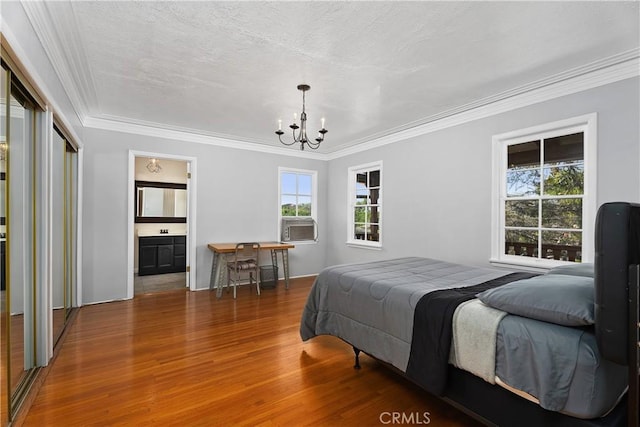 4485 Myrtle Ave, Long Beach, CA 90807 - bedroom featuring a chandelier, a textured ceiling, connected bathroom, wood finished floors, and crown molding