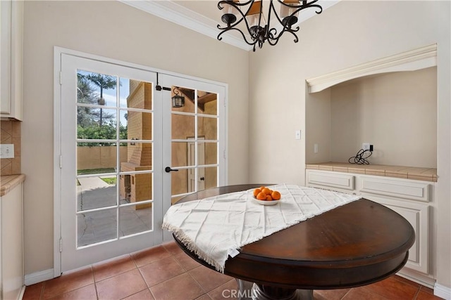 4485 Myrtle Ave, Long Beach, CA 90807 - tiled dining area with ornamental molding, french doors, and an inviting chandelier
