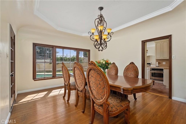 4485 Myrtle Ave, Long Beach, CA 90807 - dining room featuring ornamental molding, light wood-style flooring, baseboards, and an inviting chandelier