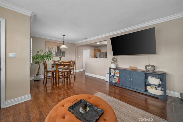 living room featuring crown molding and dark hardwood / wood-style floors