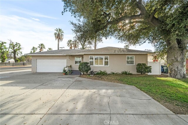 ranch-style house featuring a front yard and a garage