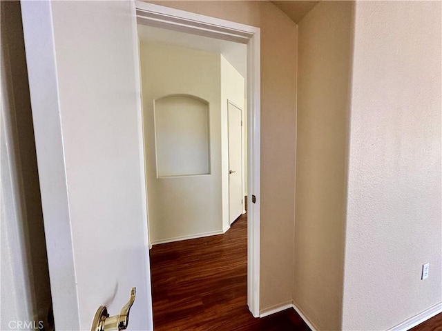 corridor with dark wood-type flooring