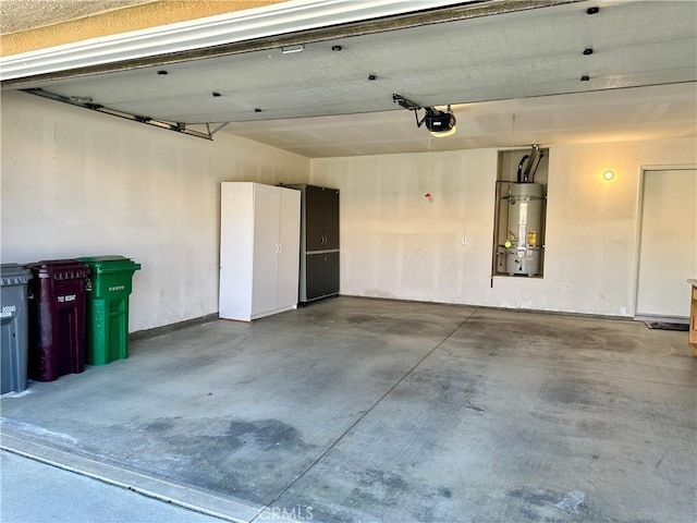 garage featuring a garage door opener and strapped water heater