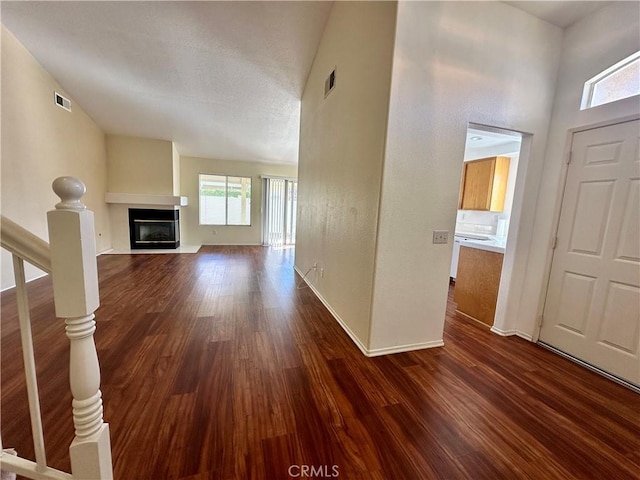 unfurnished living room featuring dark wood-type flooring