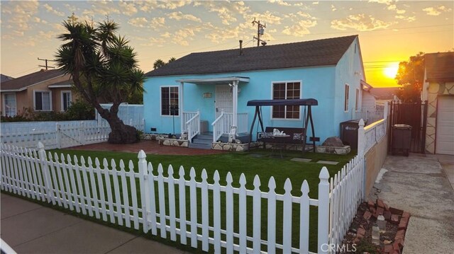 bungalow-style house featuring a lawn