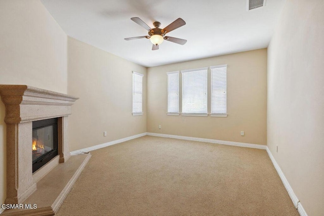 unfurnished living room with ceiling fan and light carpet