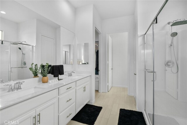 bathroom featuring walk in shower and vanity