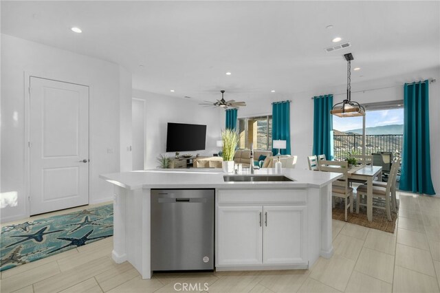 kitchen with dishwasher, sink, hanging light fixtures, an island with sink, and white cabinets