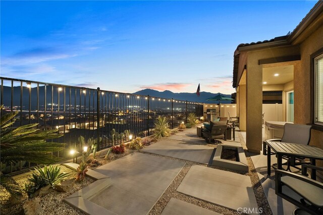 patio terrace at dusk with a mountain view