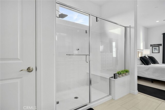 bathroom featuring tile patterned floors and a shower with door