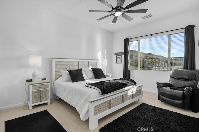 bedroom with ceiling fan and light carpet