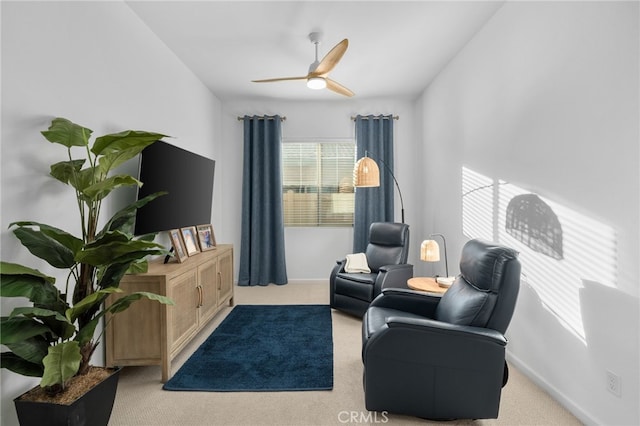 sitting room featuring ceiling fan and light carpet