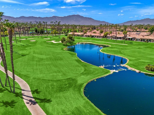 surrounding community with a water and mountain view