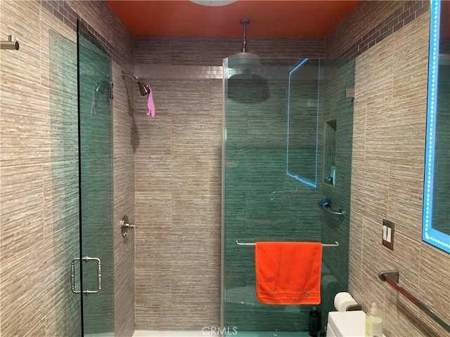 bathroom featuring a shower with door