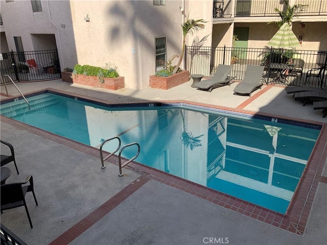 view of swimming pool with a patio area