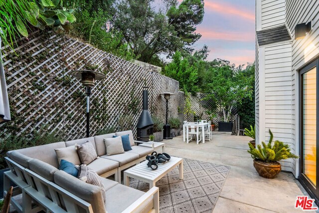 patio terrace at dusk featuring outdoor lounge area